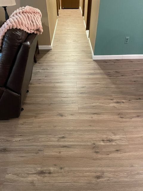 A living room with hardwood floors and a couch.