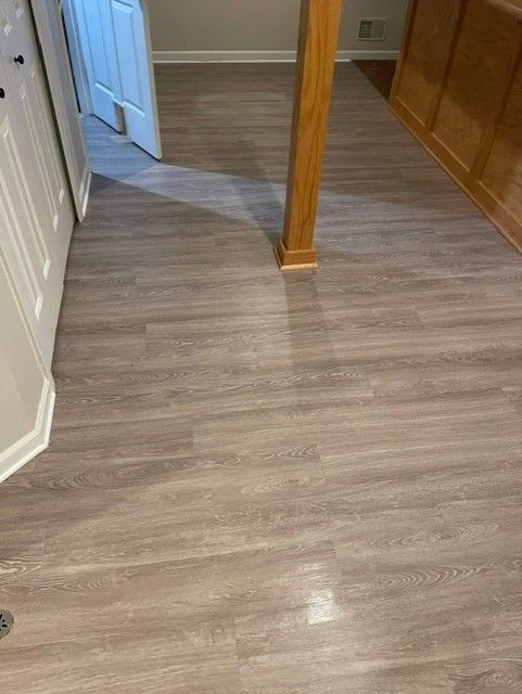 A room with a wooden floor and a door.