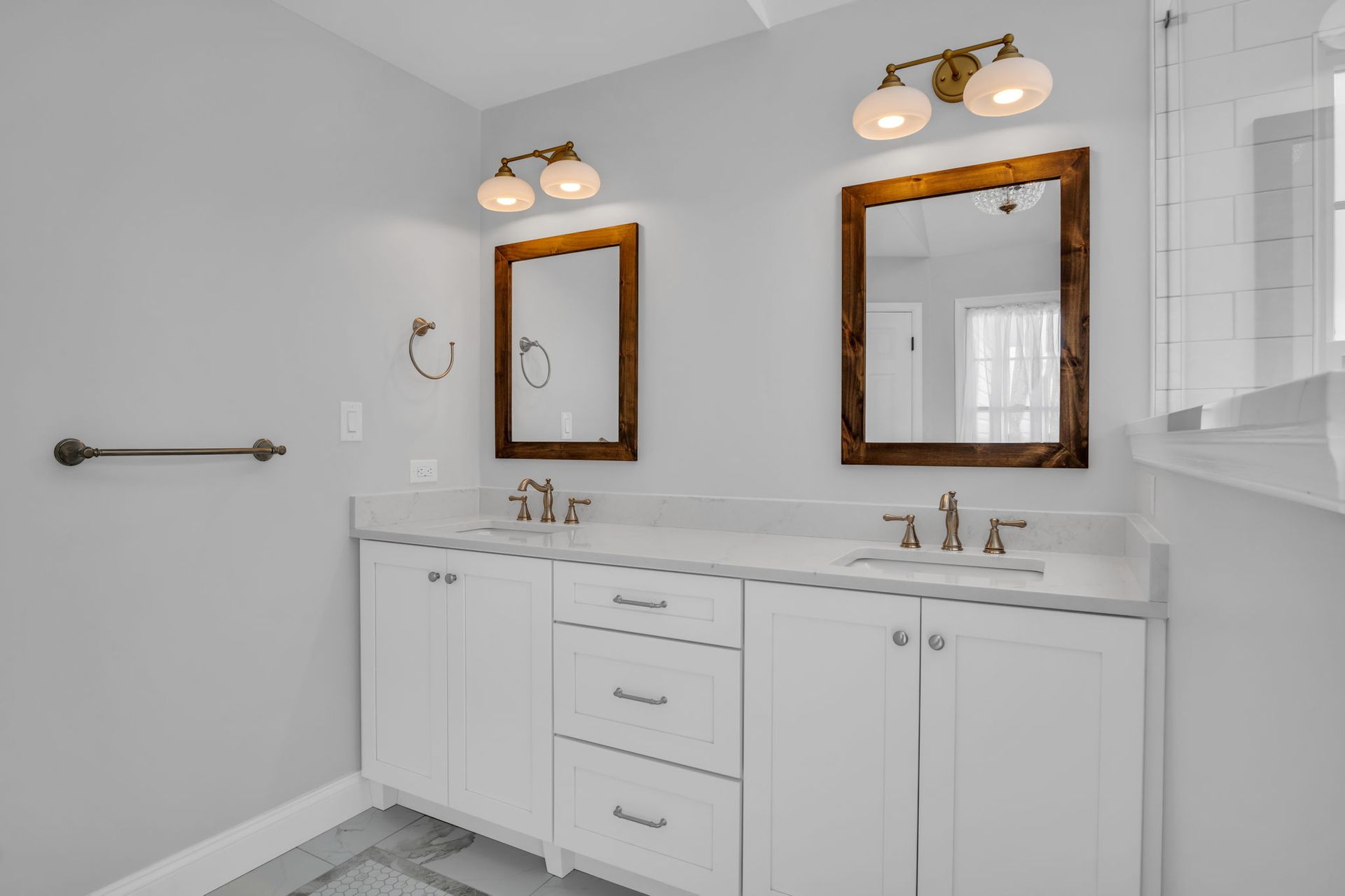 A bathroom with two sinks and two mirrors.