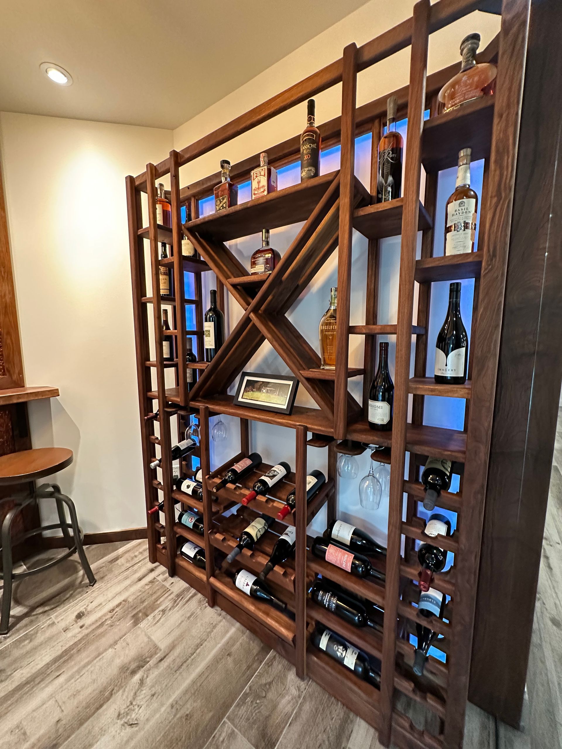 A large wooden wine rack filled with bottles of wine.