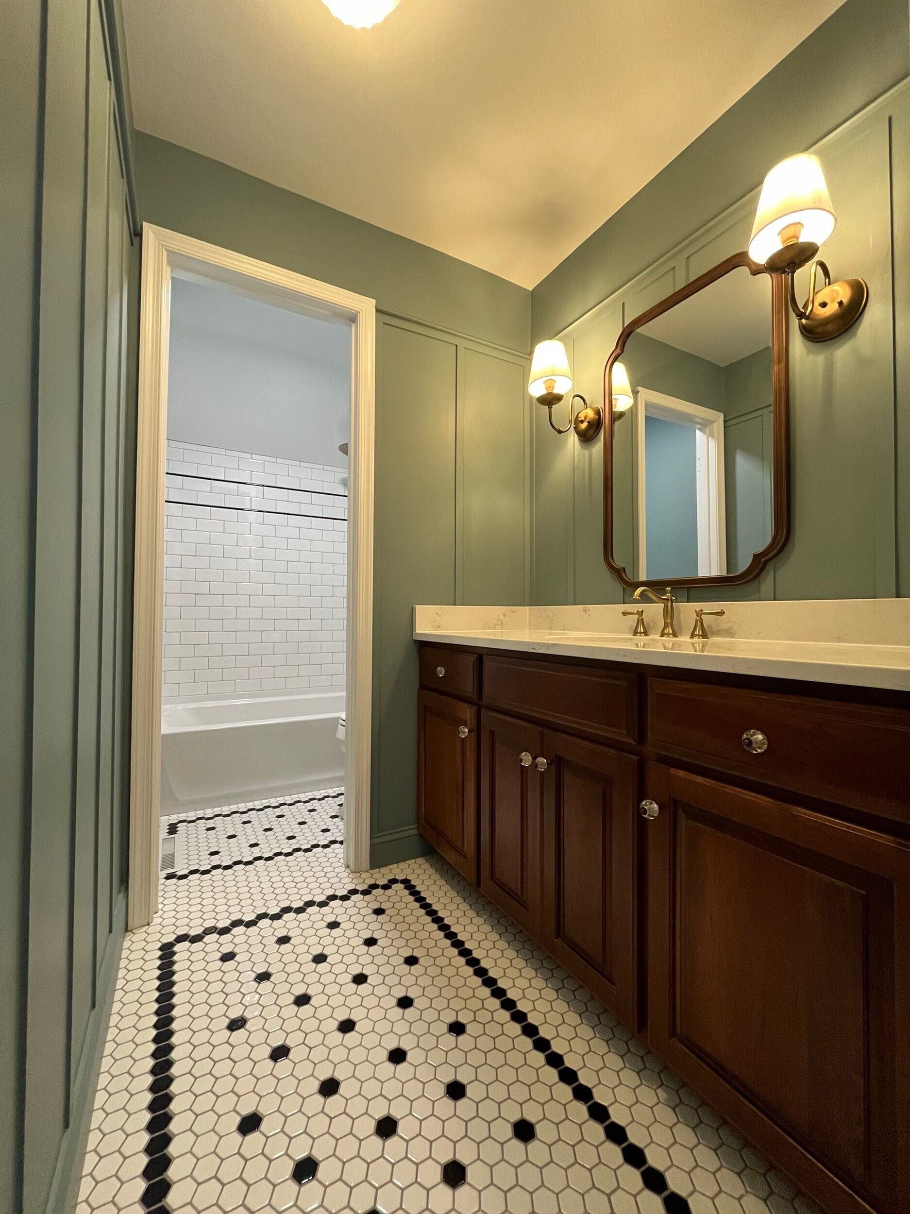 A bathroom with two sinks and a mirror