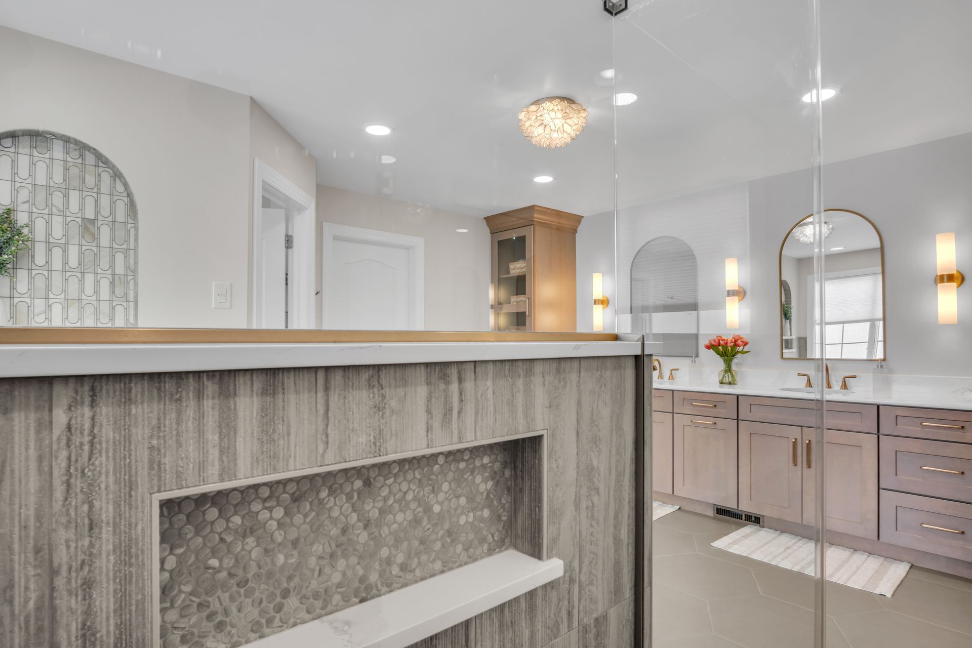 A bathroom with a walk in shower and two sinks.