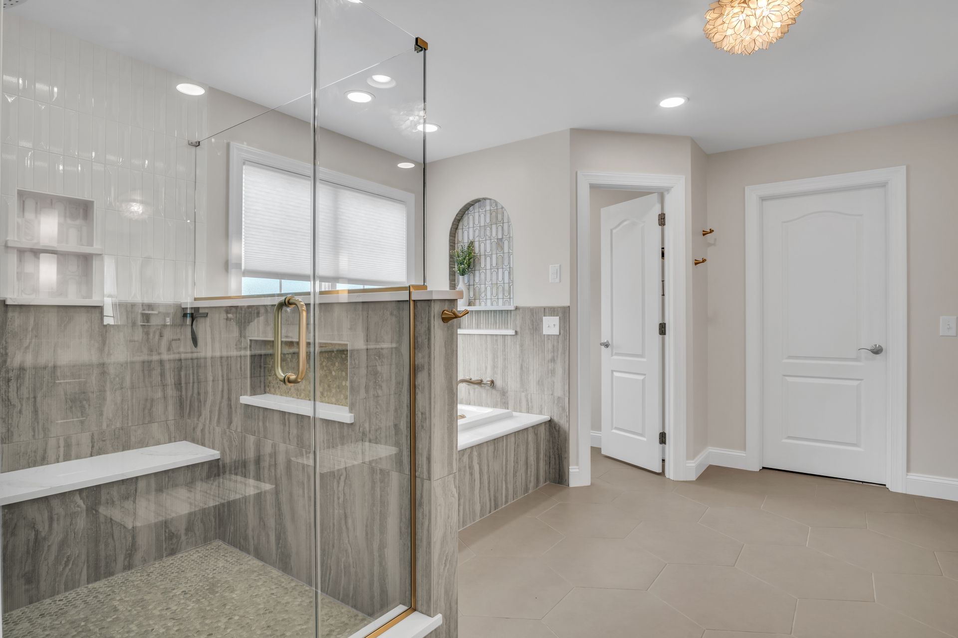 A bathroom with a walk in shower and a bathtub.