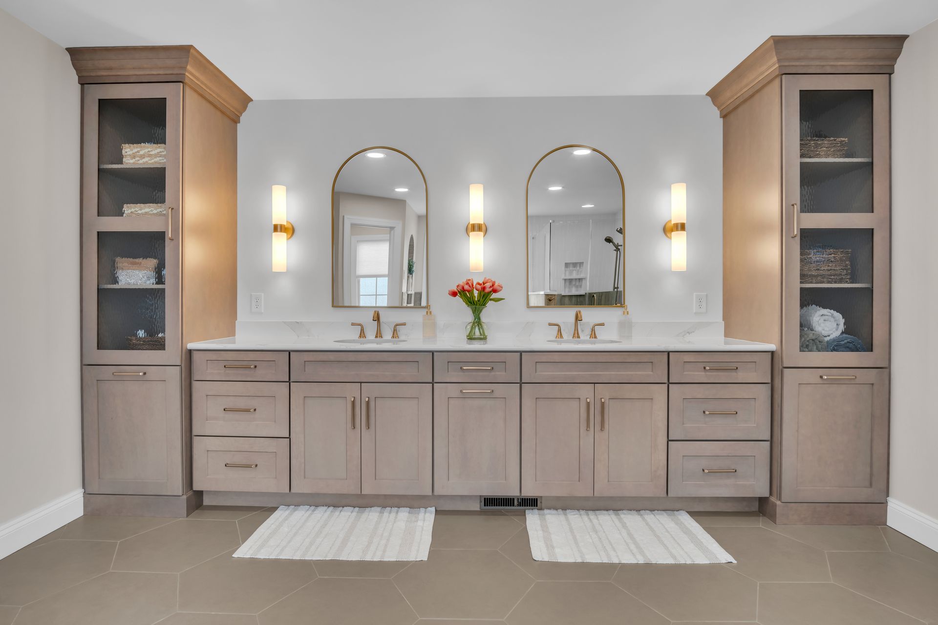 A bathroom with two sinks and two mirrors