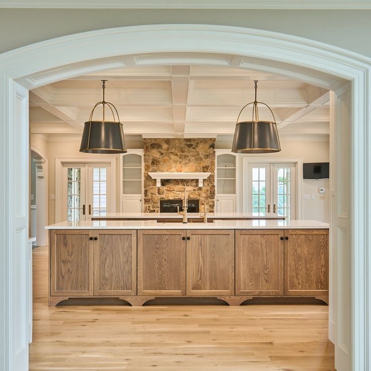 A kitchen with wooden cabinets and a stone fireplace