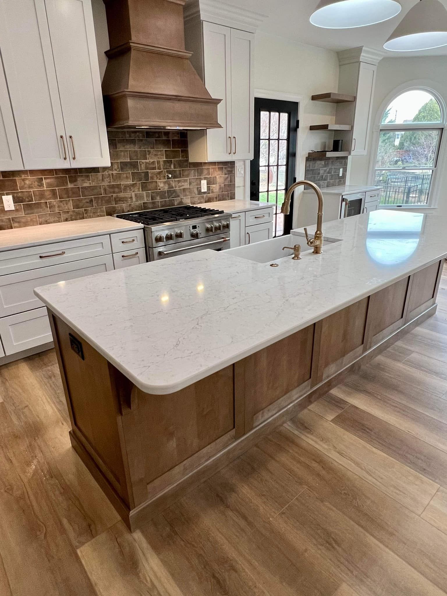 A kitchen with a large island and a sink.
