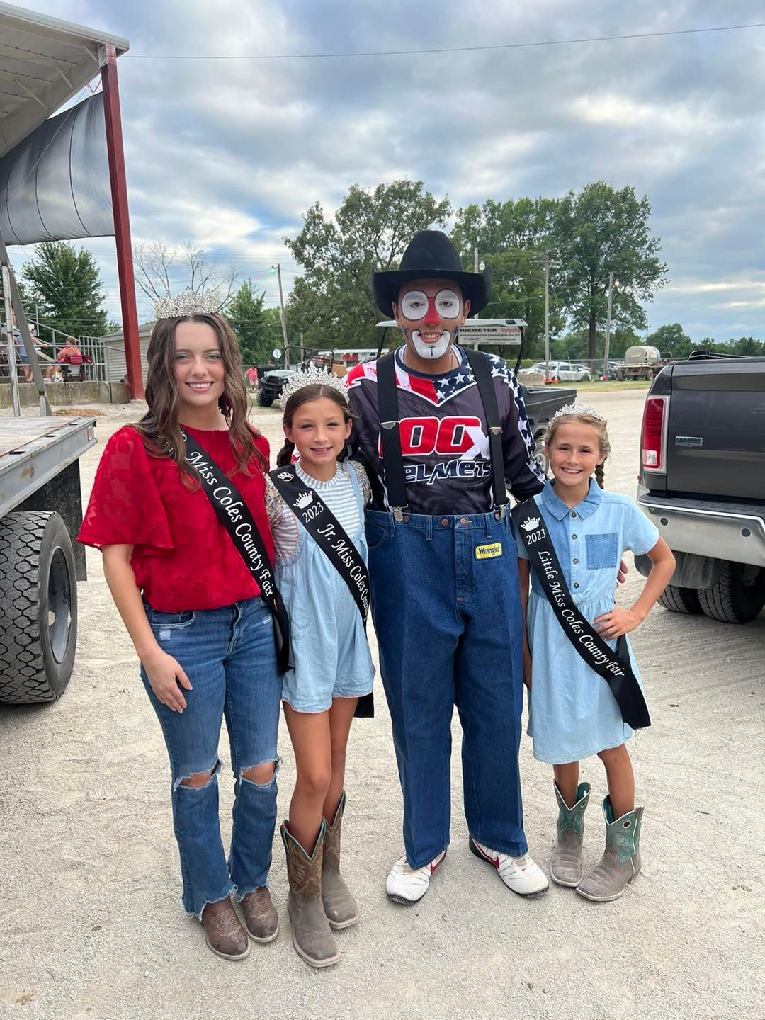 A group of people standing next to each other in front of a truck.