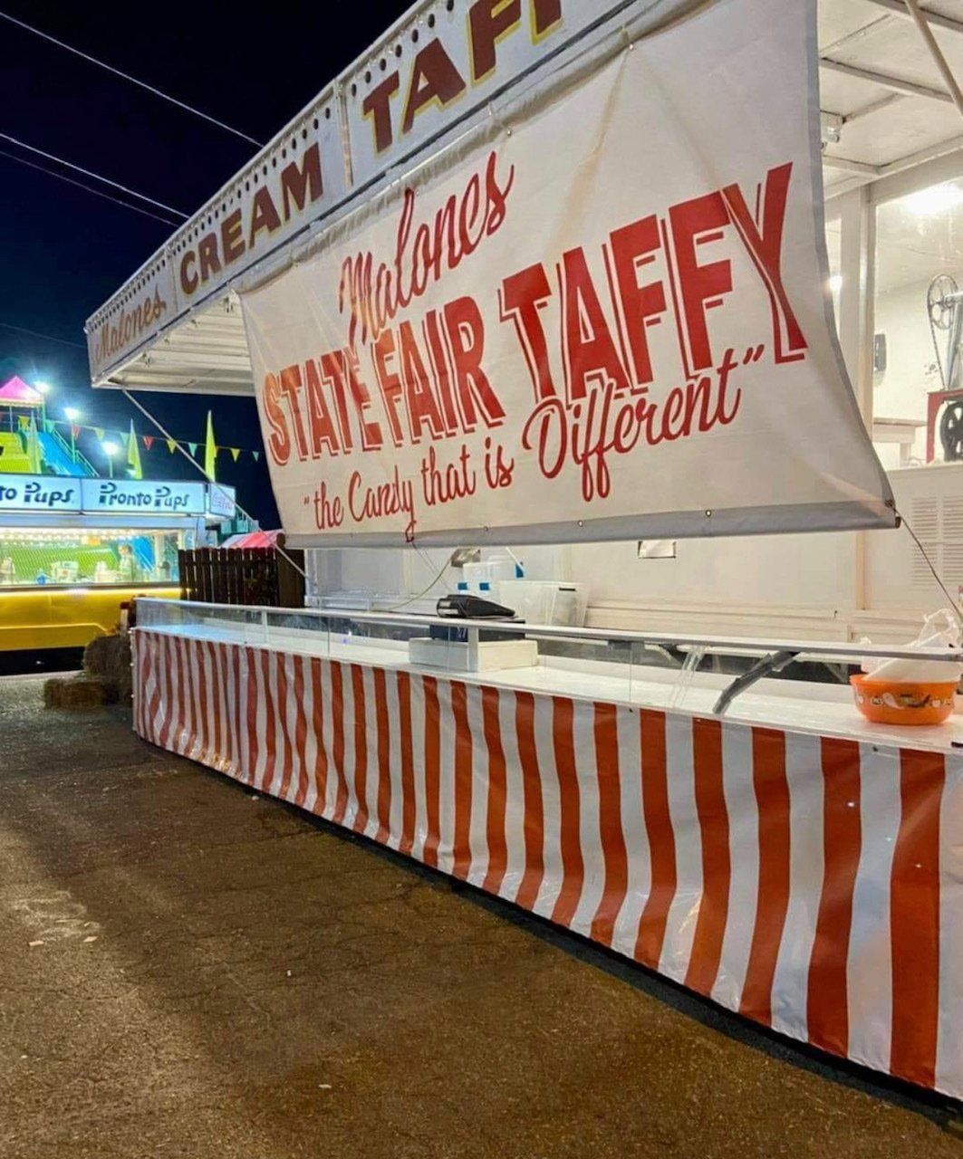 A sign that says malones state fair taffy on it