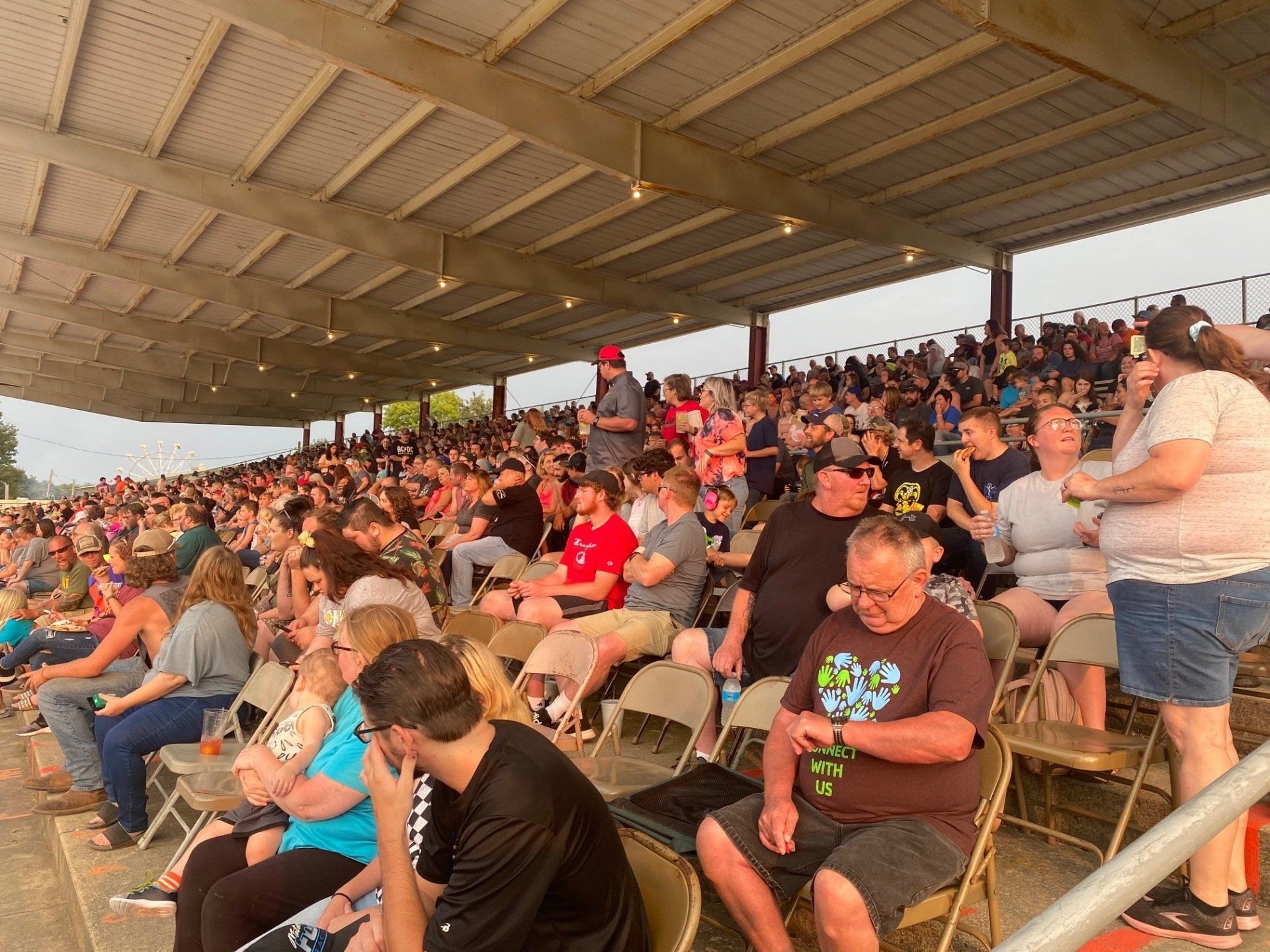A crowd of people are sitting in a stadium watching a game.