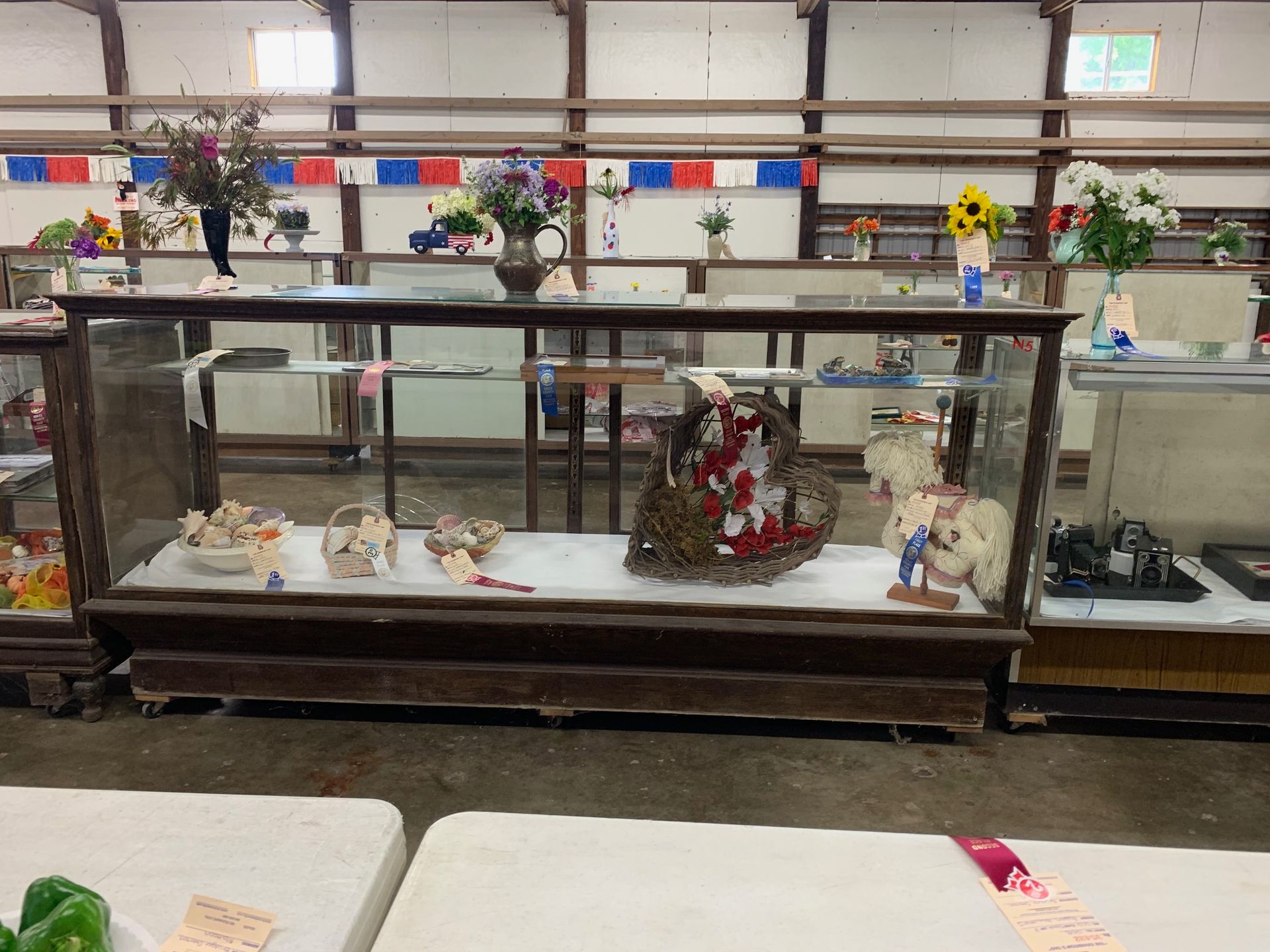 A display case with a wreath on top of it in a store.