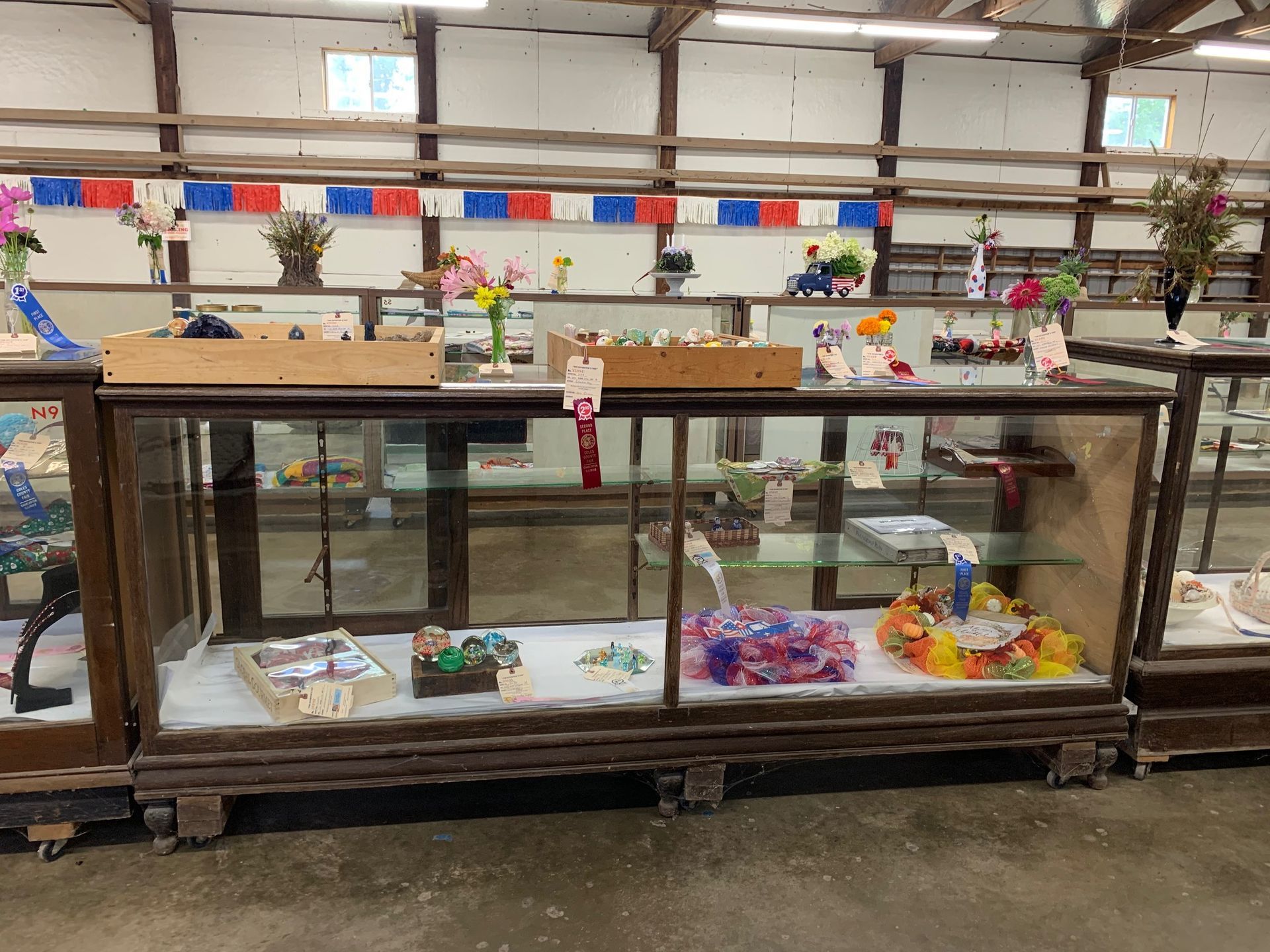 A row of glass display cases filled with various items.