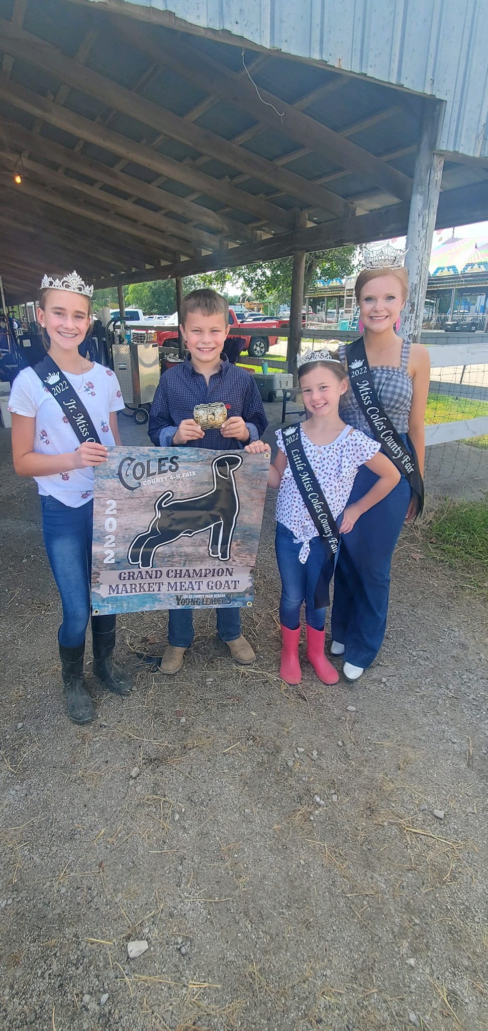 A group of young girls standing next to each other holding a sign. bull 