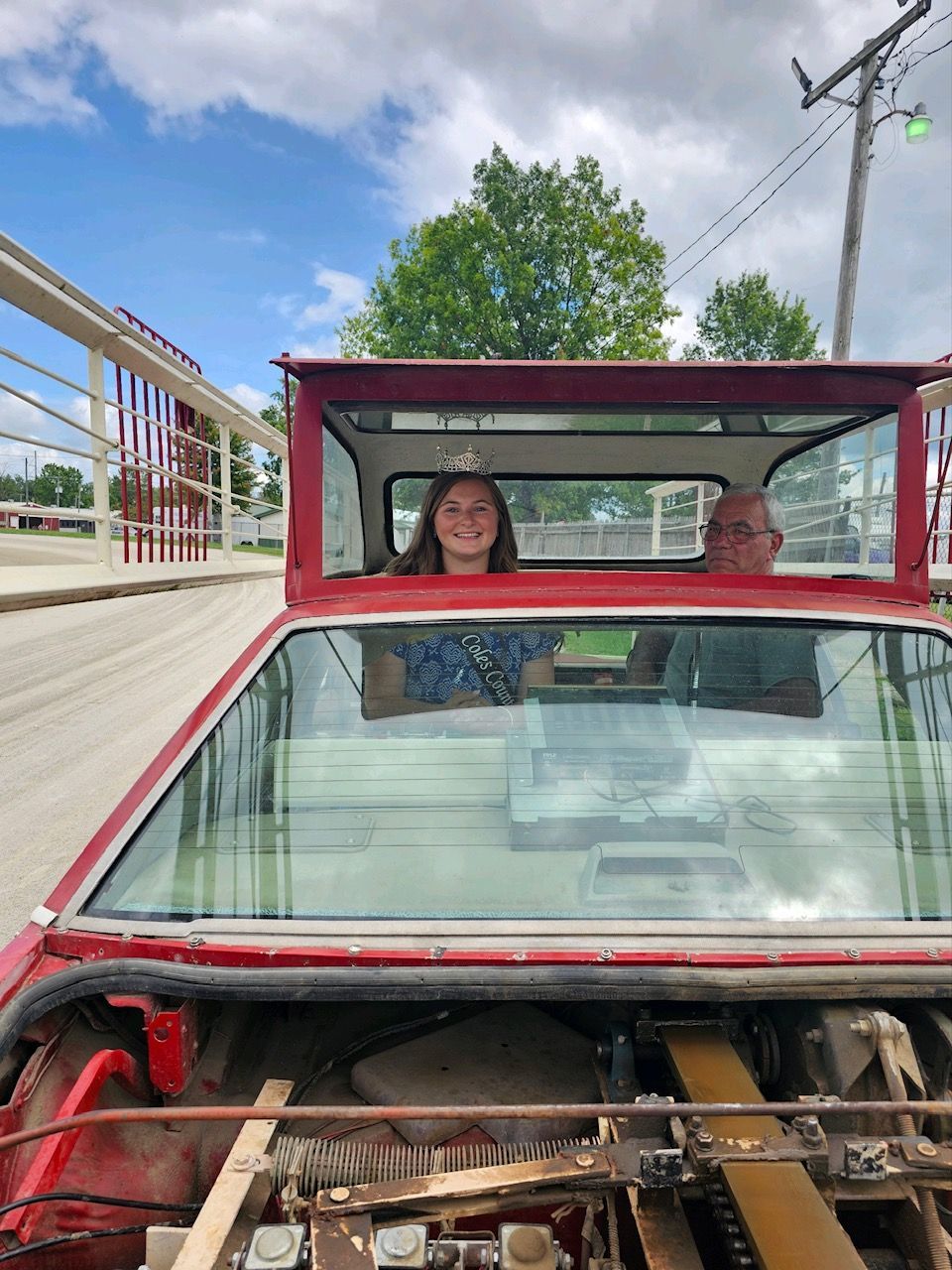 A man and a woman are sitting in a red car.