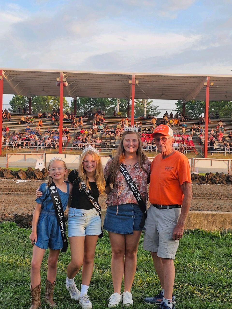 A group of people standing next to each other in a field.