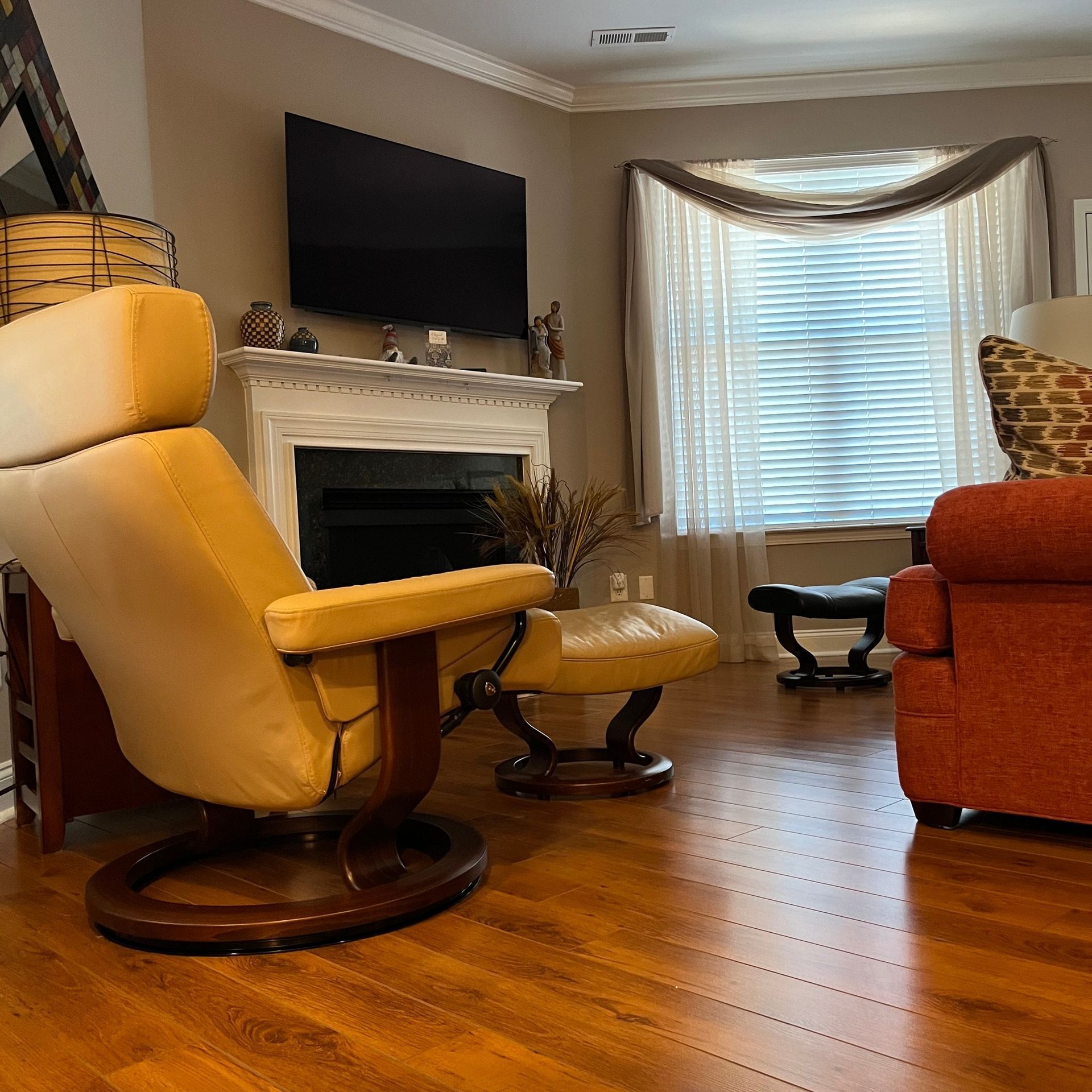 Empty room with gray walls, beige carpet, and a doorway leading to a vanity area with a mirror.