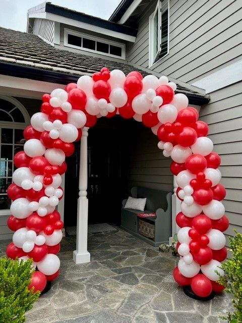 red and white arch balloons