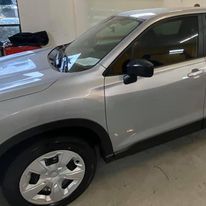 A silver car is parked in a garage.