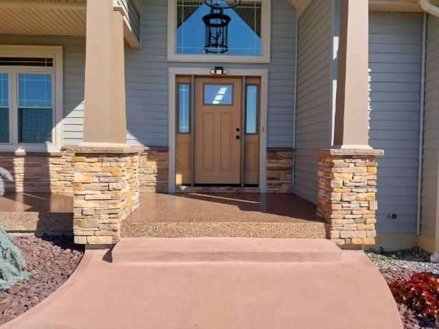 The front door of a house with a stone walkway leading to it