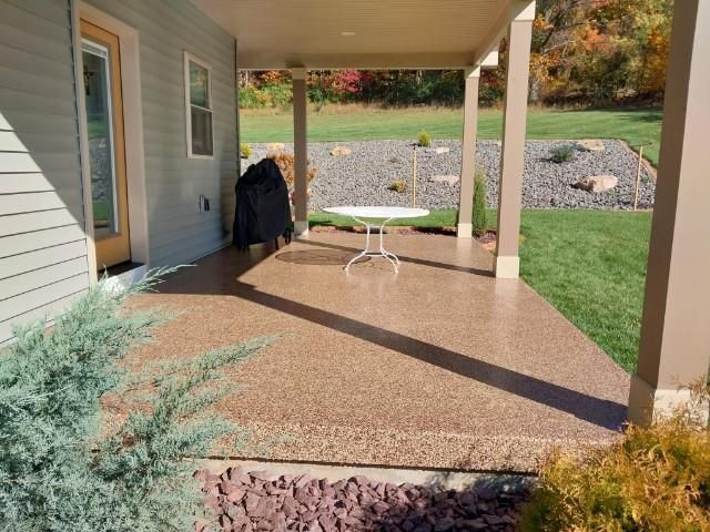 There is a table on the porch of a house.