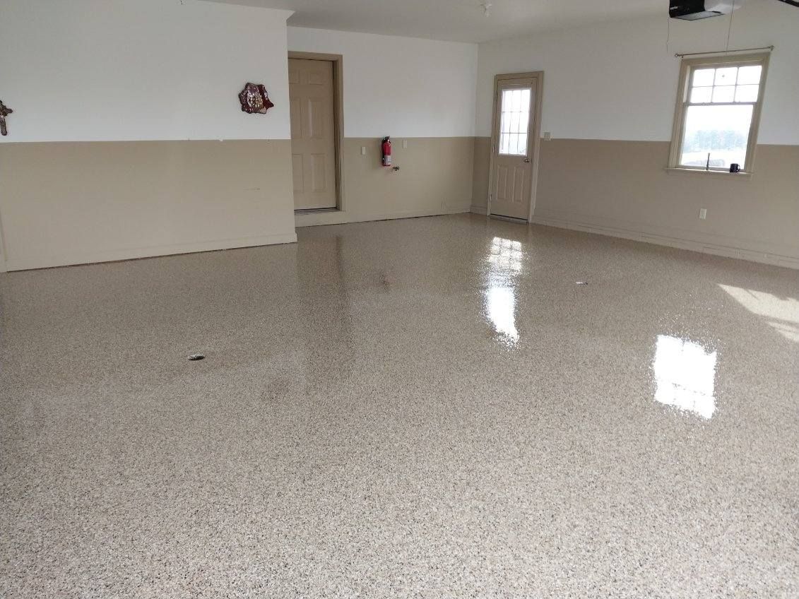 A large empty room with a shiny floor and white walls.
