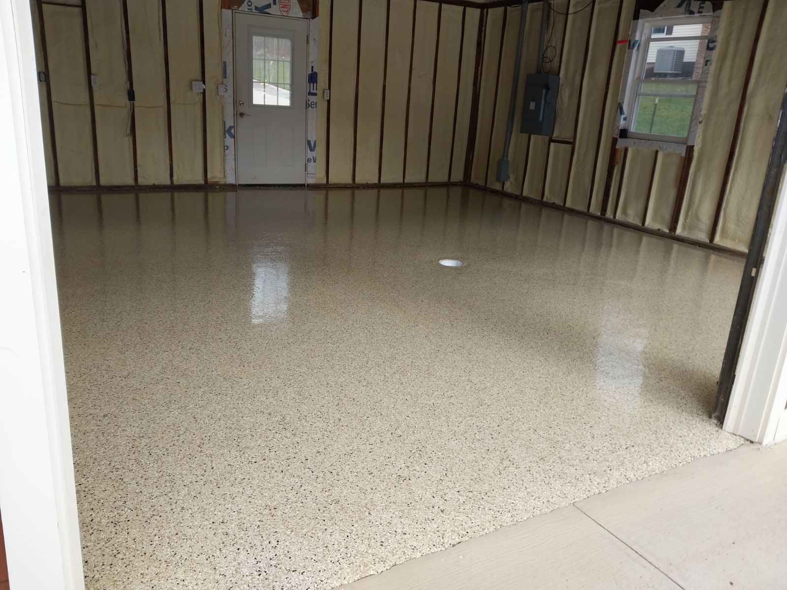 A garage with a shiny floor and a white door