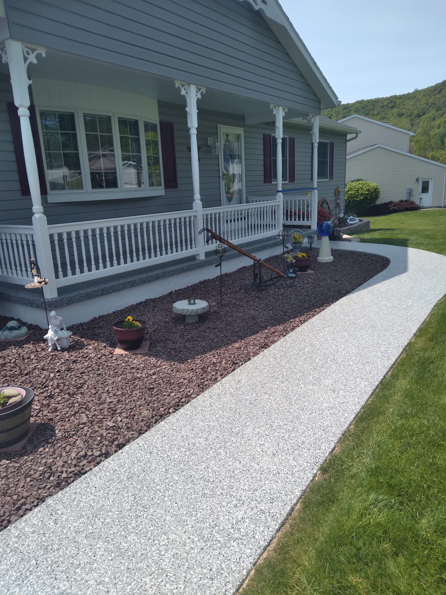 A house with a porch and a walkway leading to it.