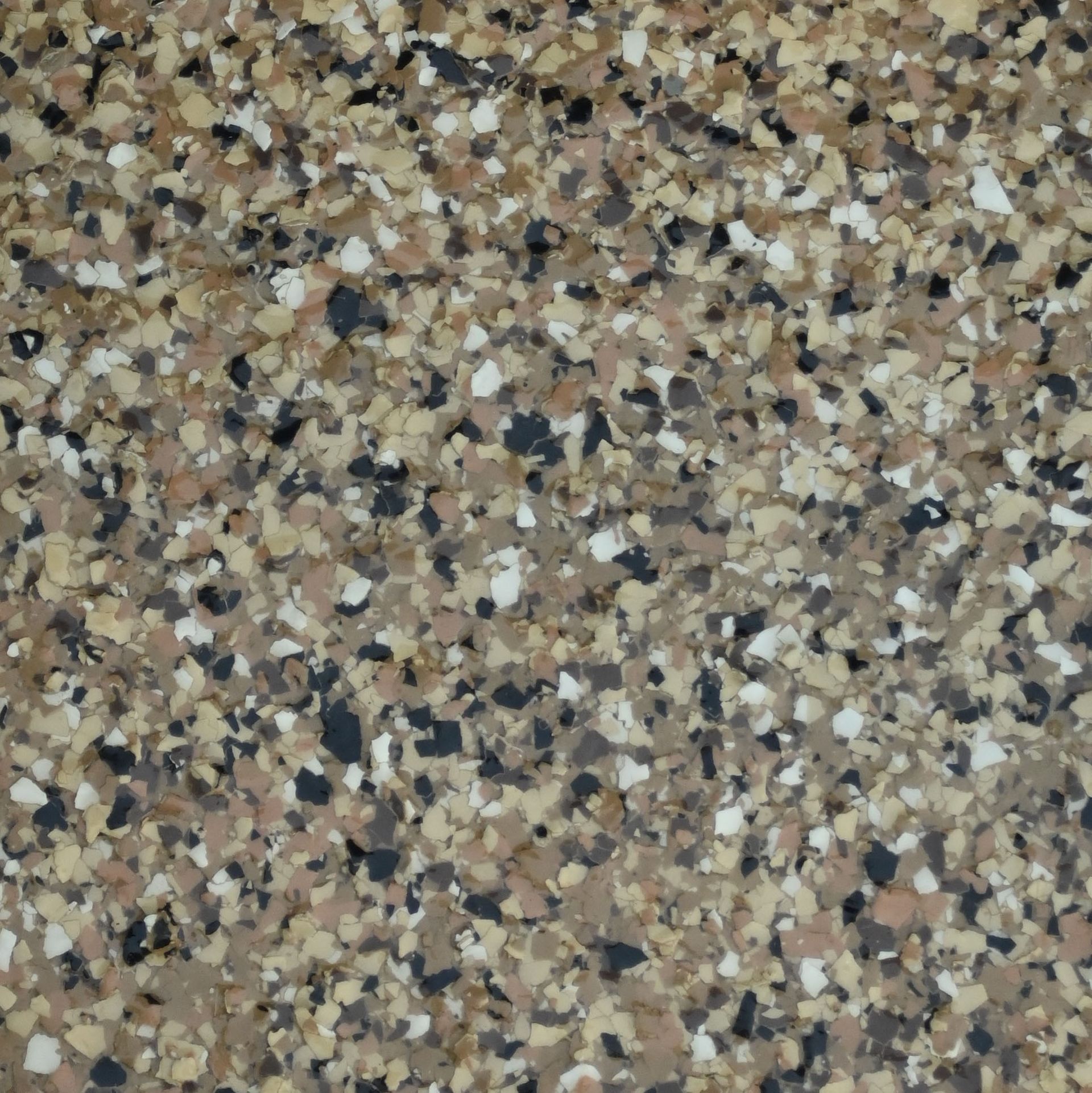 A piece of autumn brown granite sits on a white cloth