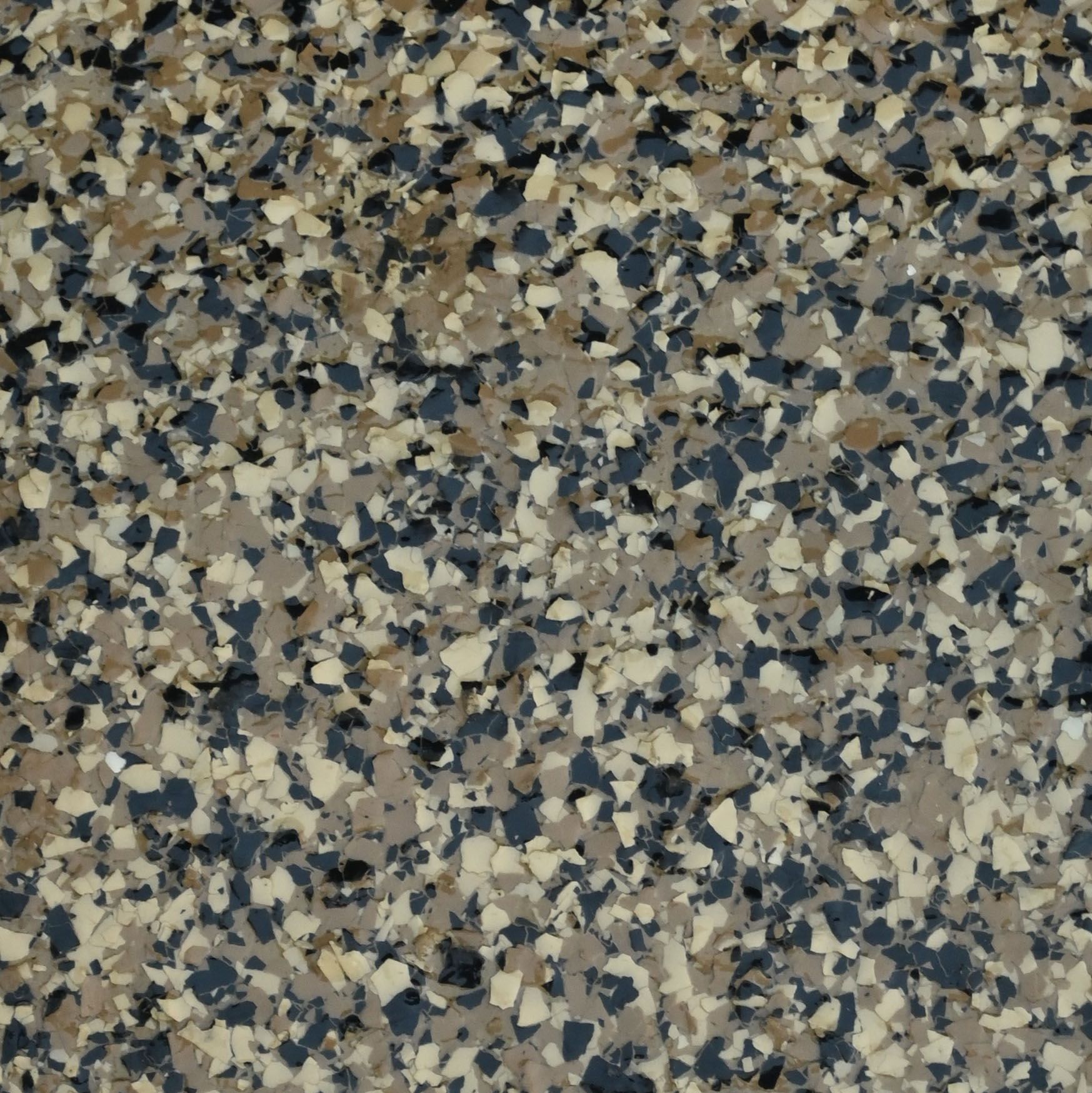 A piece of saddle beige granite sits on a white surface