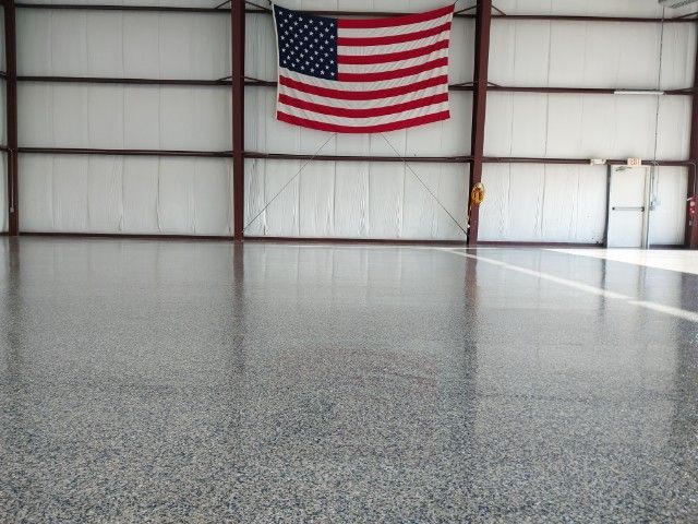 An american flag hangs from the ceiling of a building.