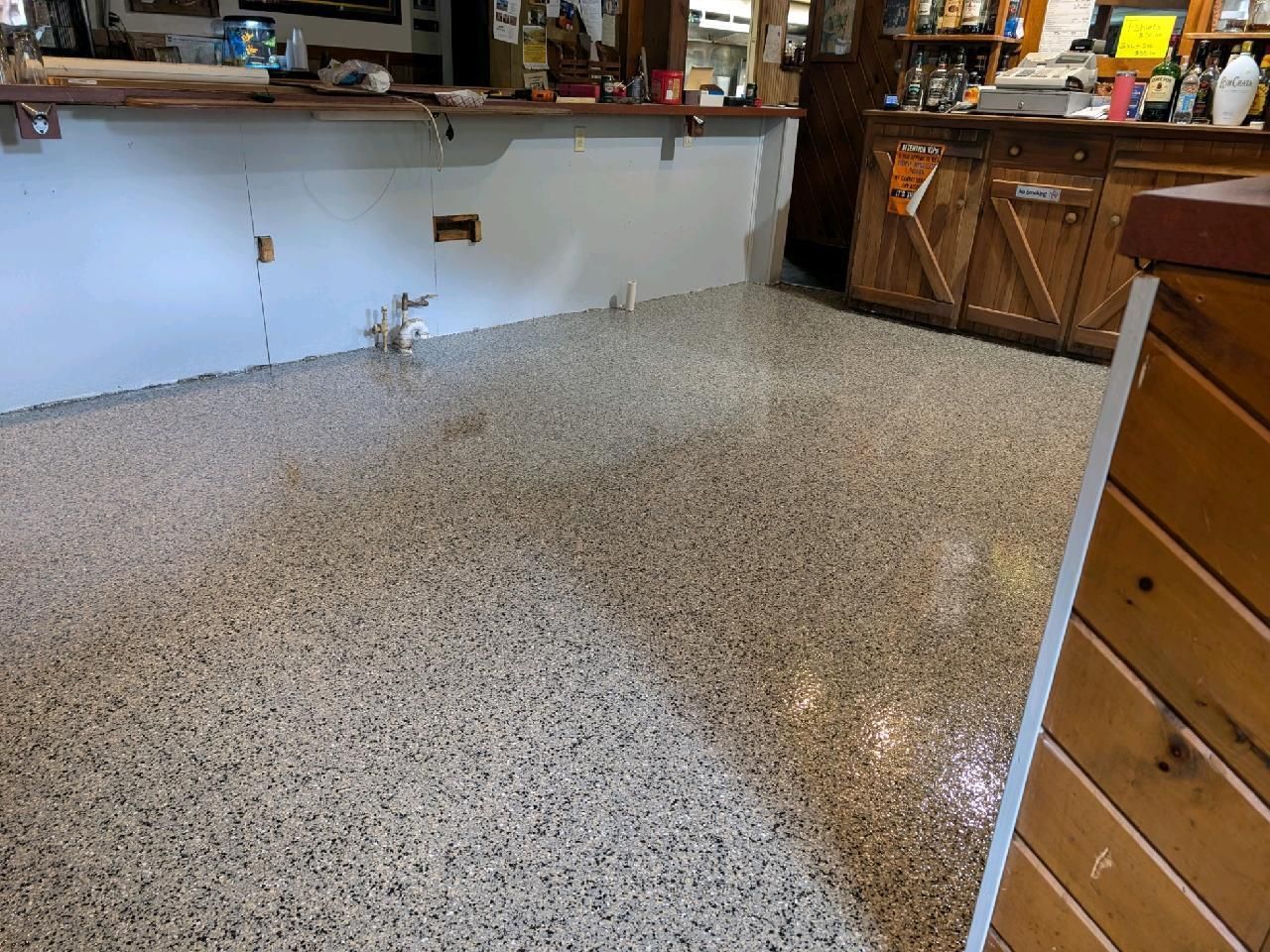 A room with a concrete floor and a wooden counter.