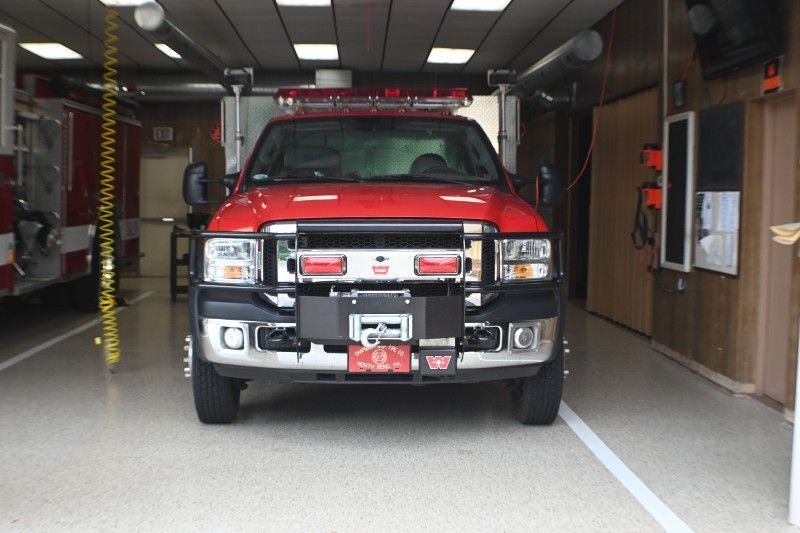 A red fire truck is parked in a garage