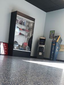 A room with a display case and a vending machine.