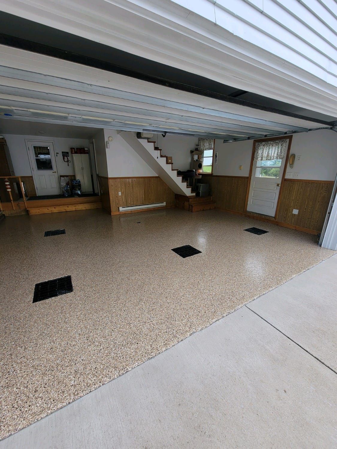 A garage with a staircase leading up to the second floor.
