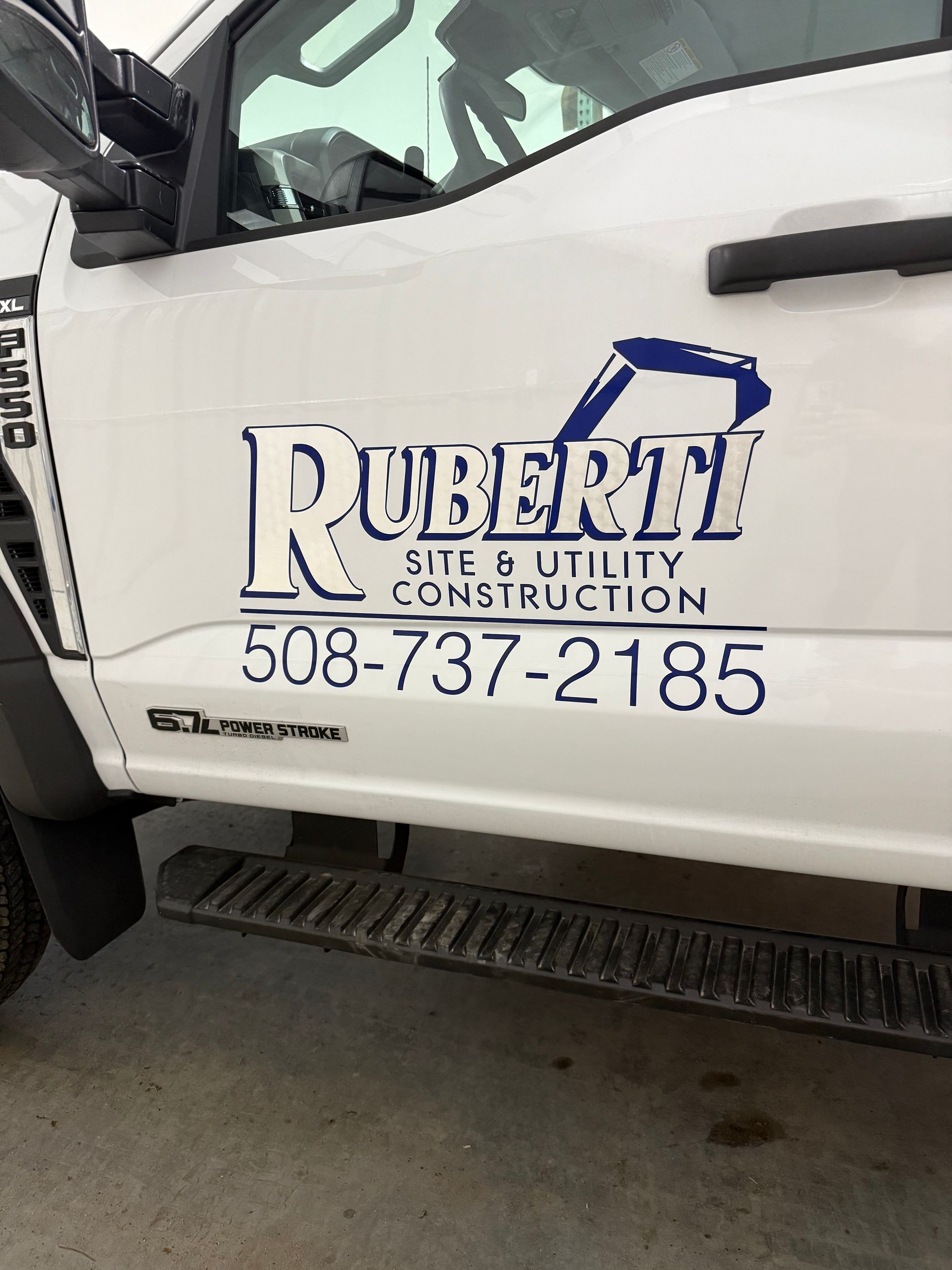 White truck with blue logo: 