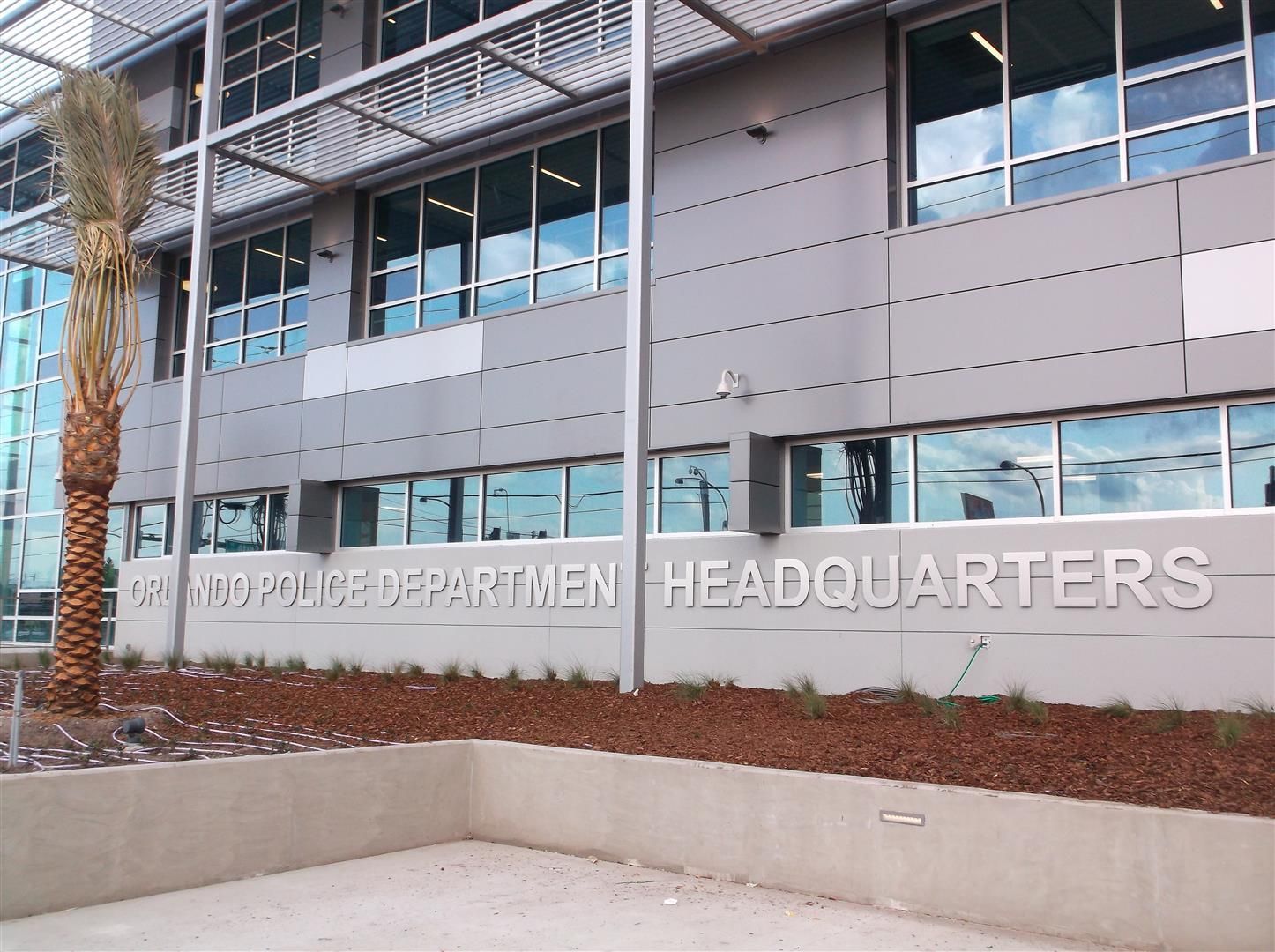 Exterior of a government department headquarters building with glass windows and gray panels