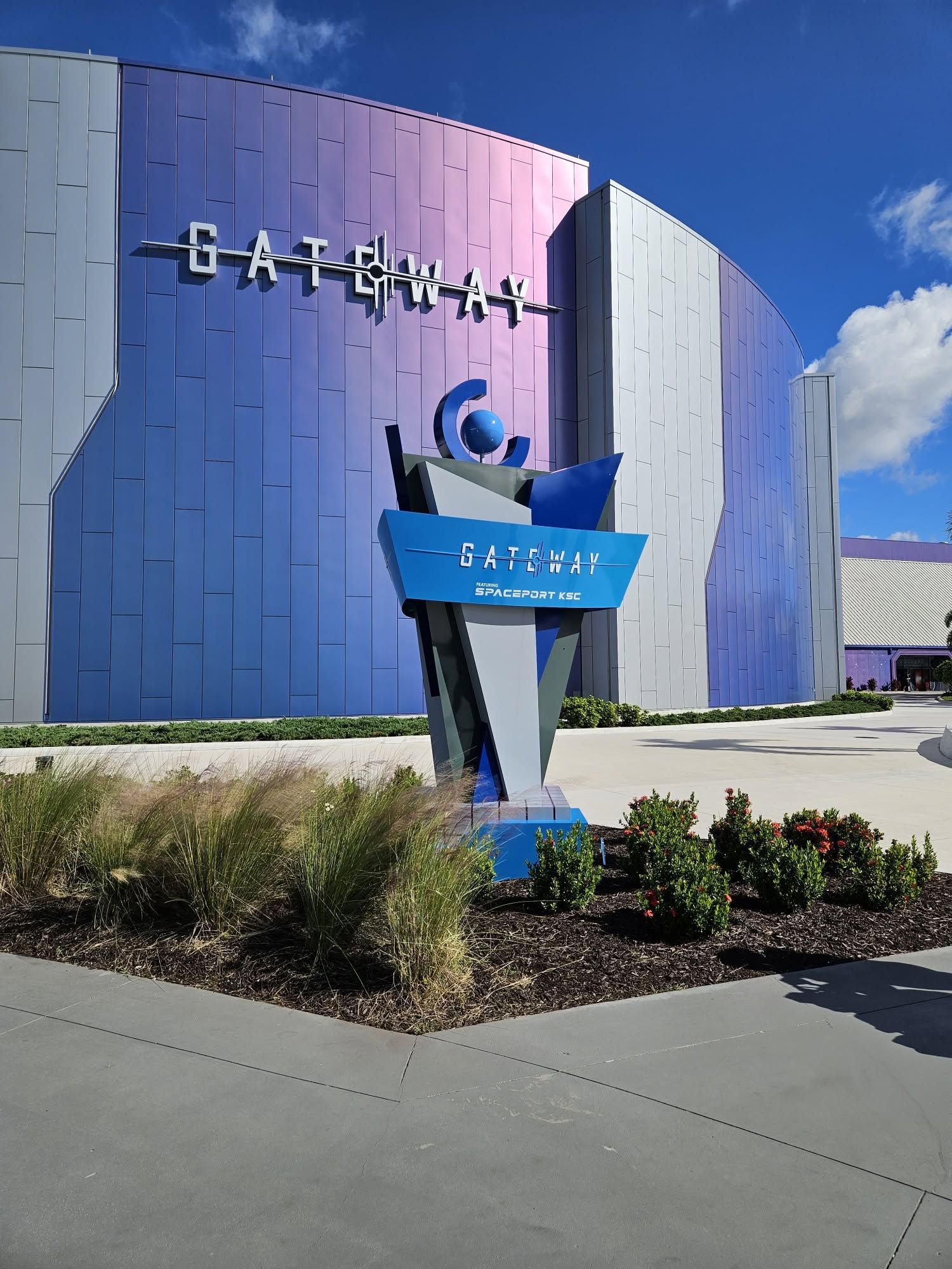 Easter-themed building exterior with a blue-purple facade and a colorful welcome sign by the entrance.