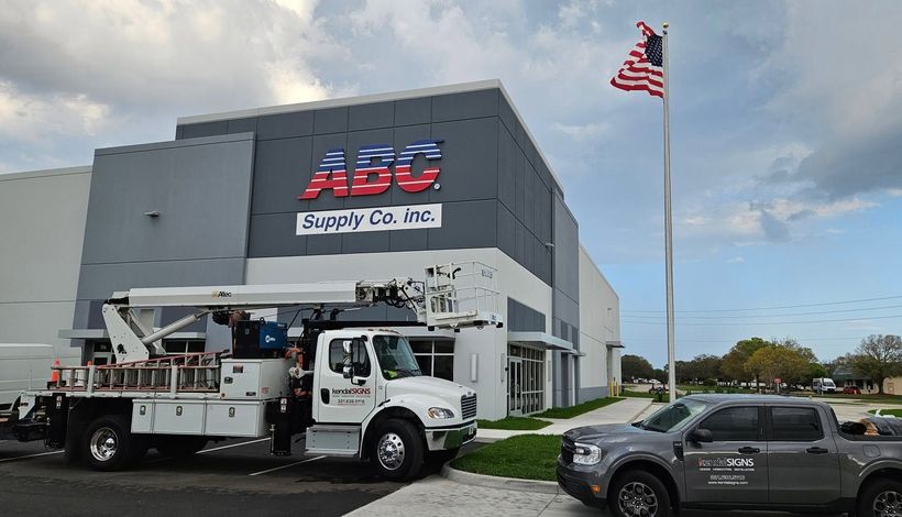 ABC Supply Co. building with a white utility truck and an American flag outside