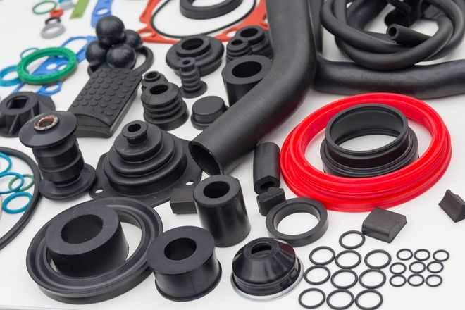 Assorted black and red rubber gaskets, rings, and hoses arranged on a white background