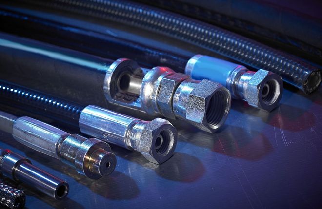 Metal cable connectors on a blue surface, lit with cool blue highlights.