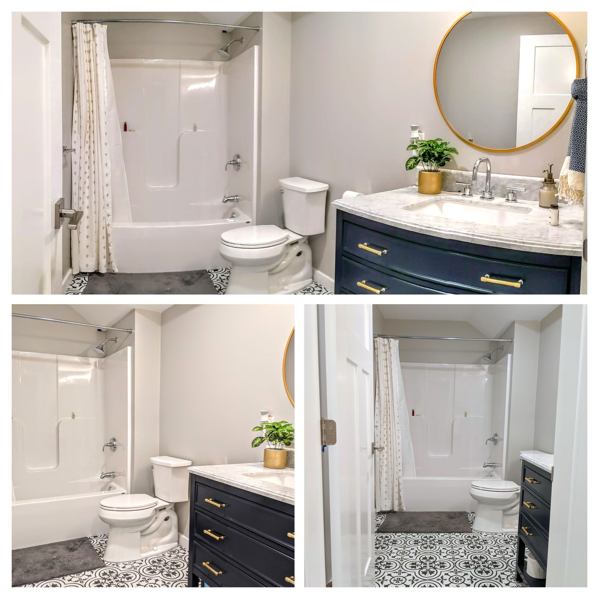 A modern bathroom with a navy vanity, gold hardware, a round mirror, and patterned black-and-white tile flooring.