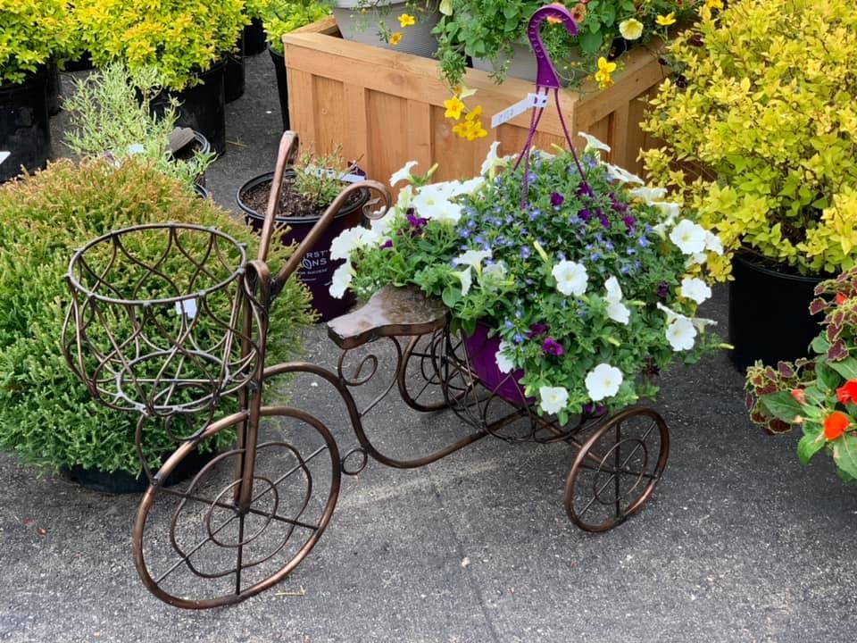 A bicycle with flowers in a basket on it