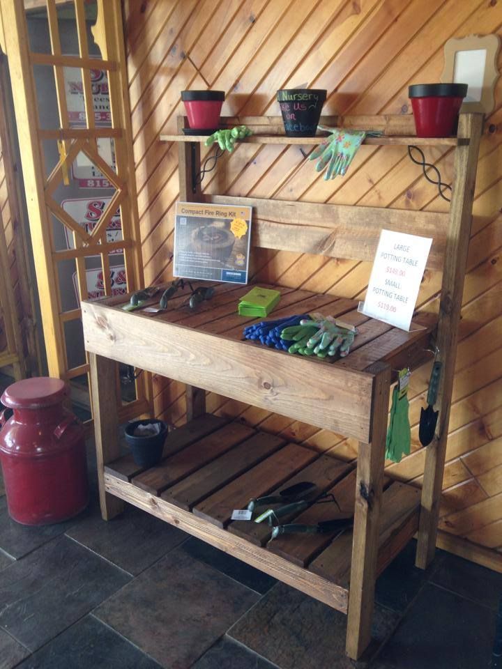 A wooden workbench with pots and gloves on it