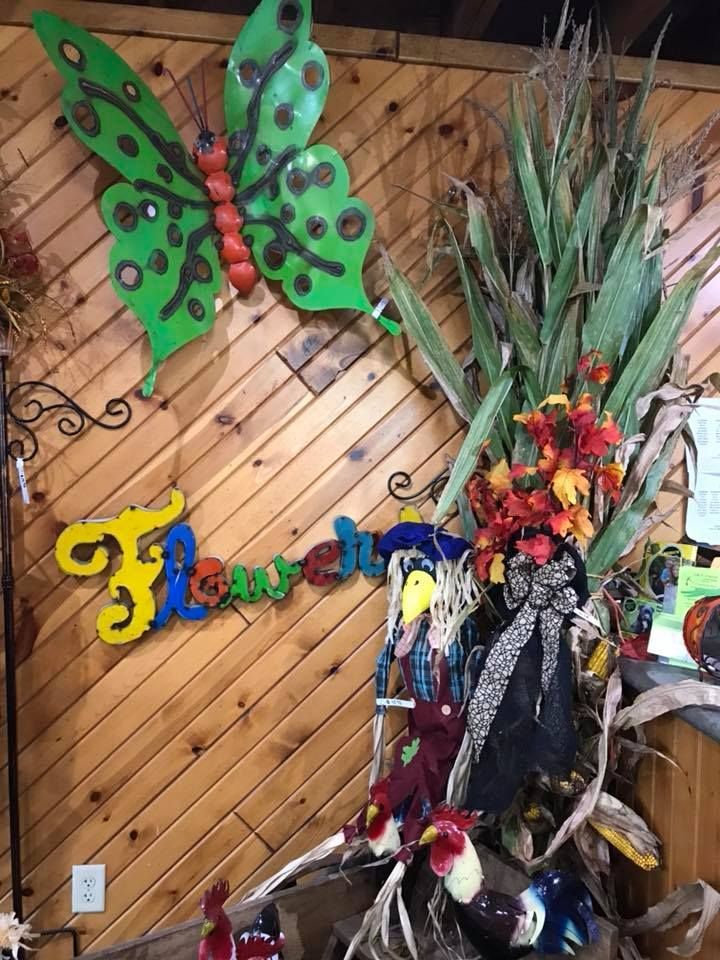 A wooden wall with a butterfly and the word flower on it