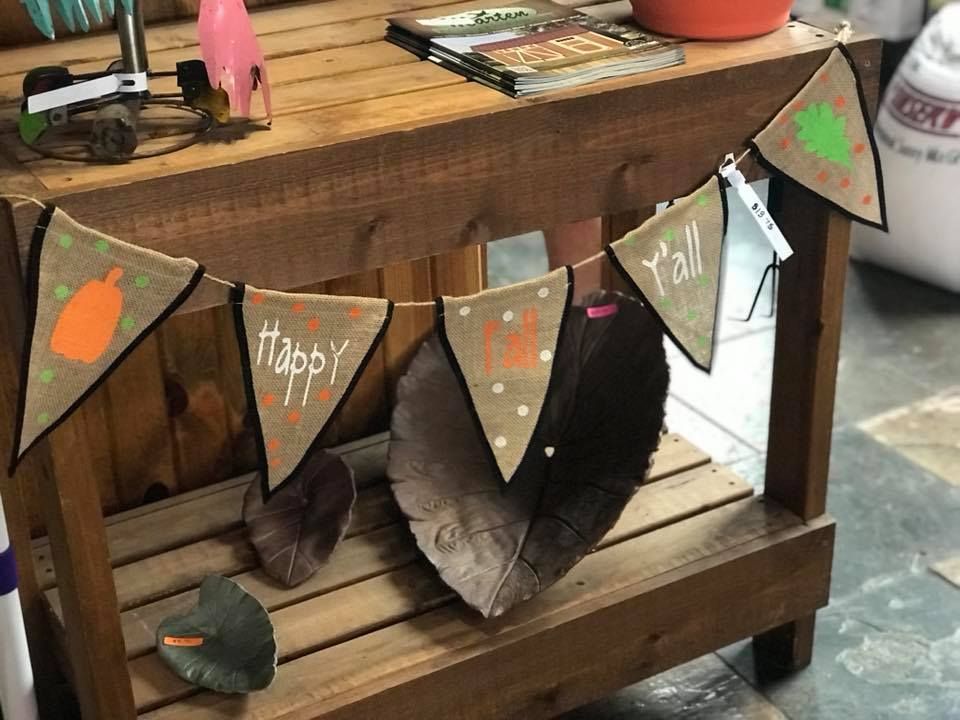 A wooden table with a bunting hanging from it.