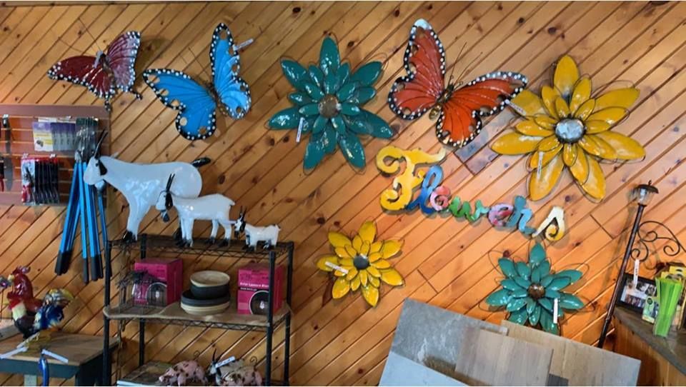 A wooden wall with flowers and butterflies on it