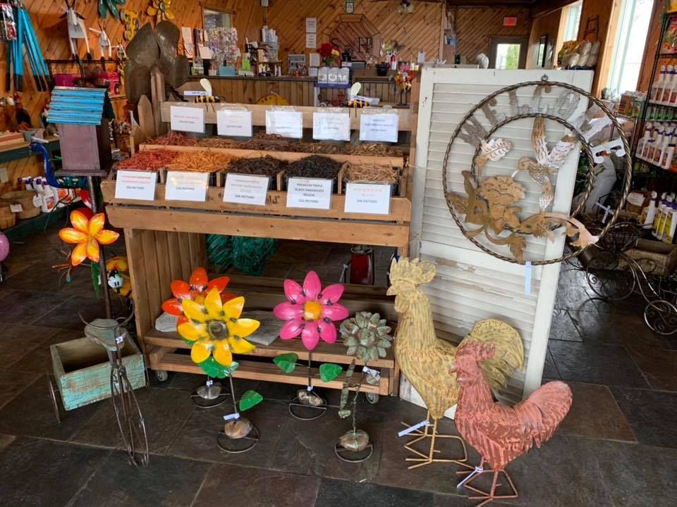 A store filled with lots of decorations including a rooster and flowers.