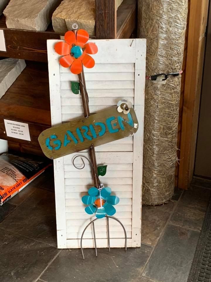 A sign that says garden is hanging on a shutter