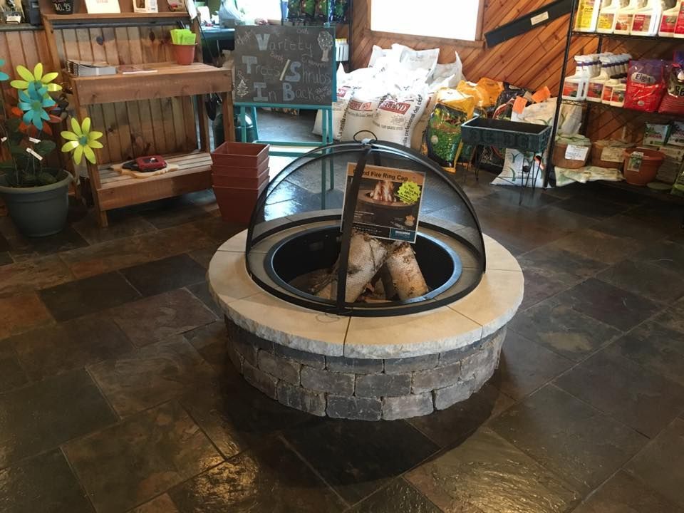 A fire pit is sitting on a tiled floor in a room.