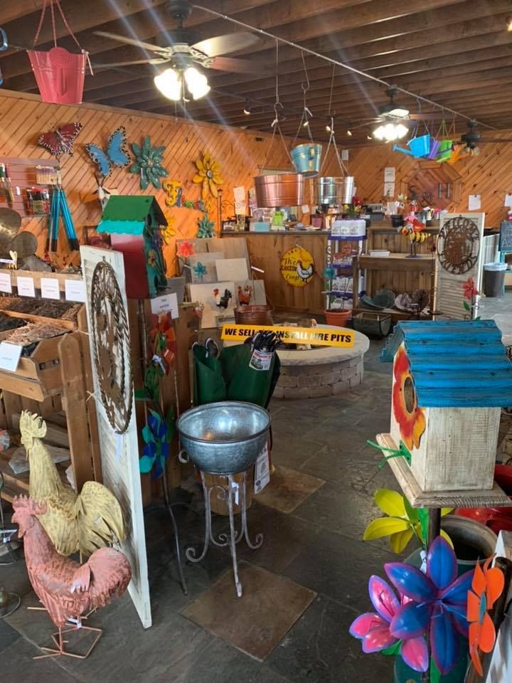 A store filled with lots of decorations including a rooster and a birdhouse.
