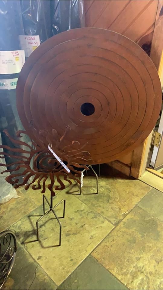 A large circular object is sitting on a tiled floor in a room.